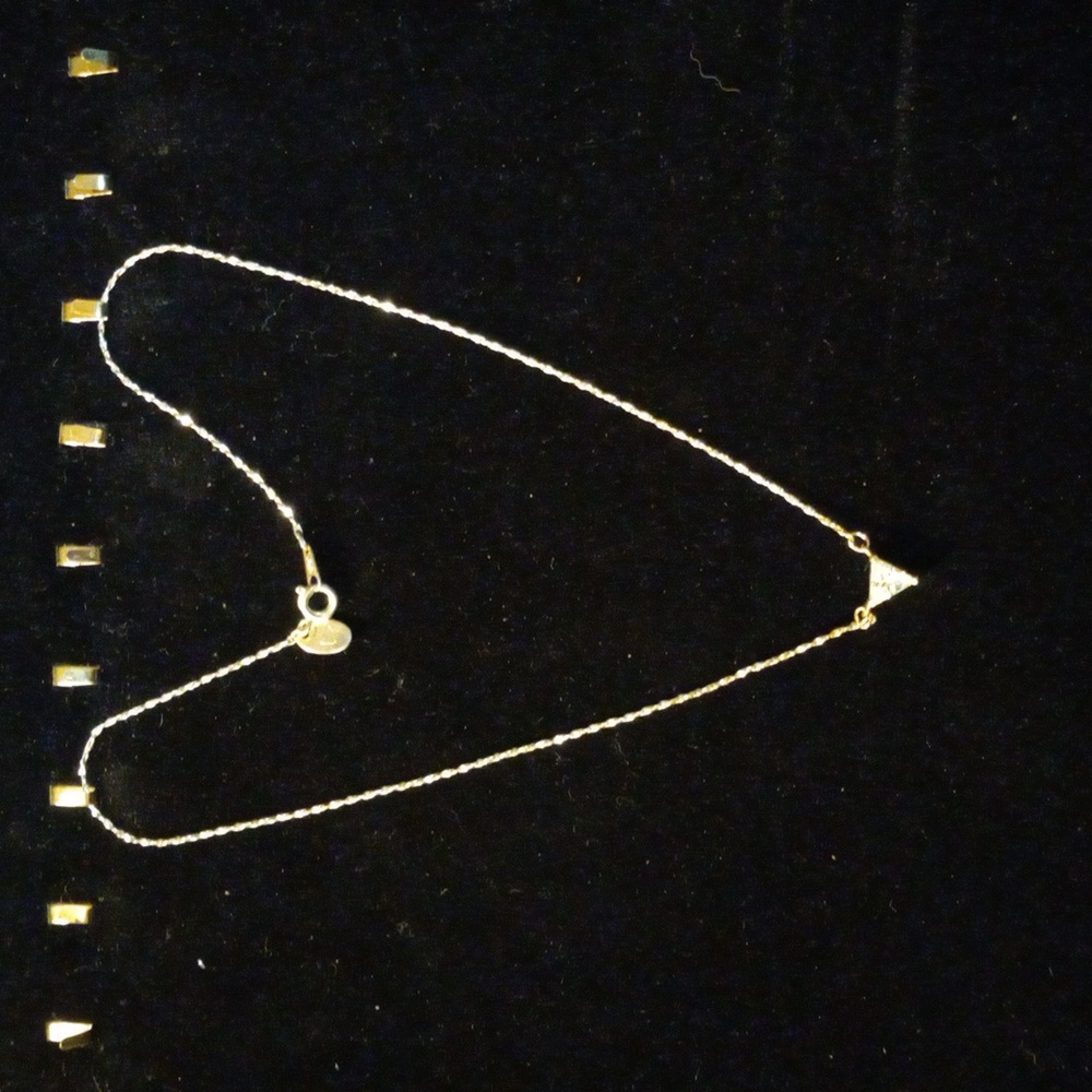 A 14 inch choker necklace with a crystal encrusted tringle.